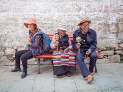 Tibet - August, 29 2014: people sitting on street bench