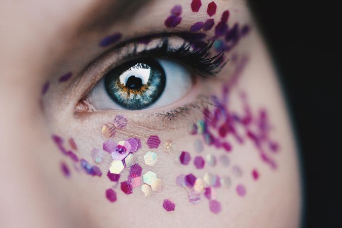 Woman's blue eye with glitter in close-up