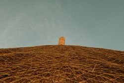 Thatched roof against blue sky