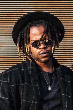 Stylish Black man with dreadlocks on street