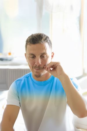A portrait of a man with moustache in his late 30's.