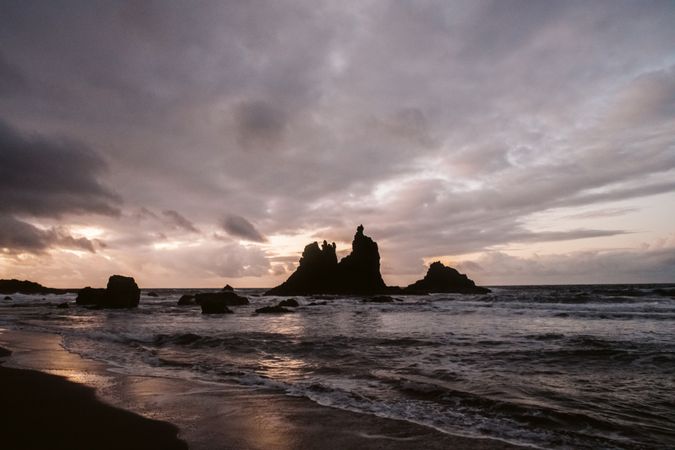 Lonely cliff in sea on cloudy day