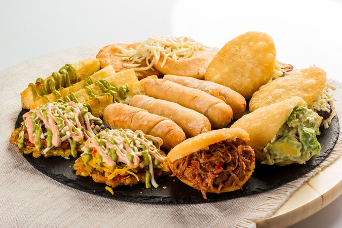 Venezuelan food tasting dish, the dish has arepas, tequeños, yuca and patacones