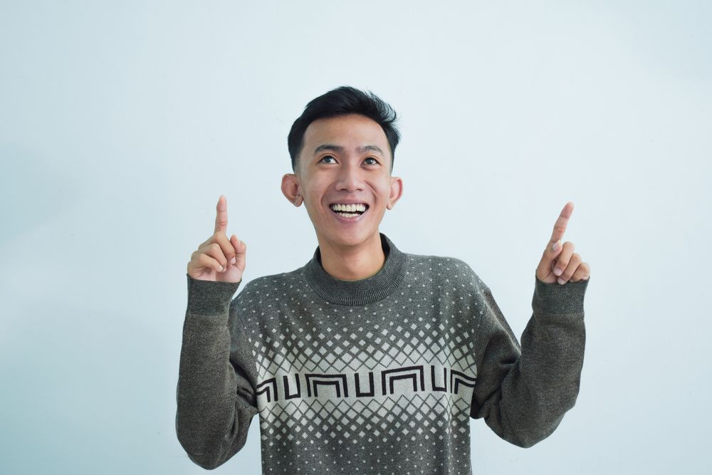 Asian man showing pointing gesture