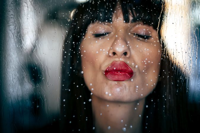 Stylish woman kissing glass