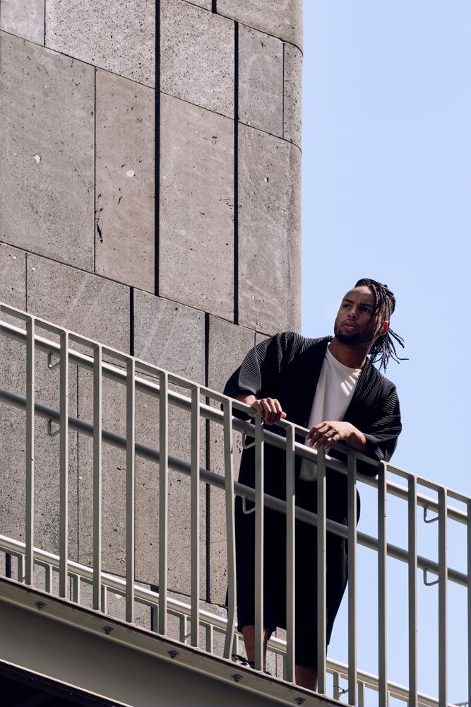 Black male standing on bridge