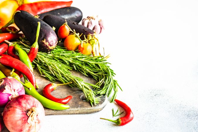 Fresh vegetables and herbs on wooden board with copy space