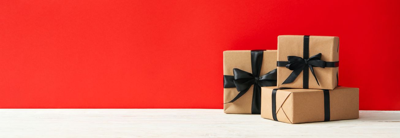Gift boxes on red background, space for text