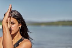Portrait of young woman holding her hands in yoga pose