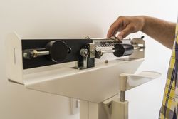 Close-up of man on weighing scale in nutritionist's office.