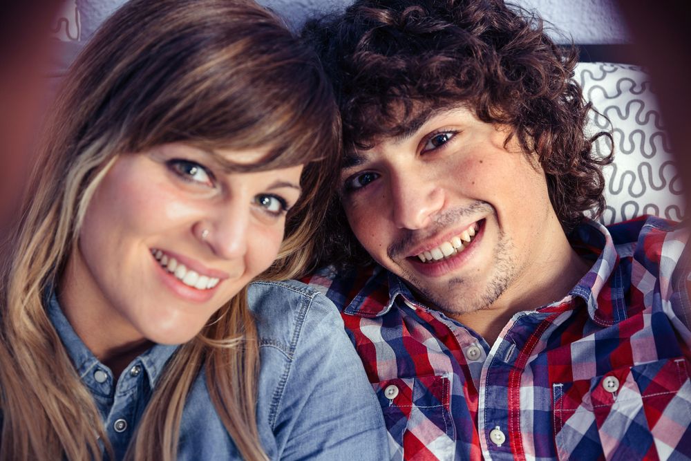 POV of couple in love taking selfie lying on bed