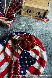 Independence Day celebration table setting on grey counter with strawberries 5ngEGA