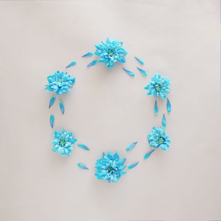 Soft blue flowers making wreath with copy space