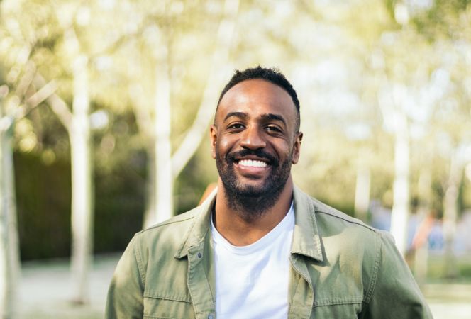 young Black man portrait in a park.