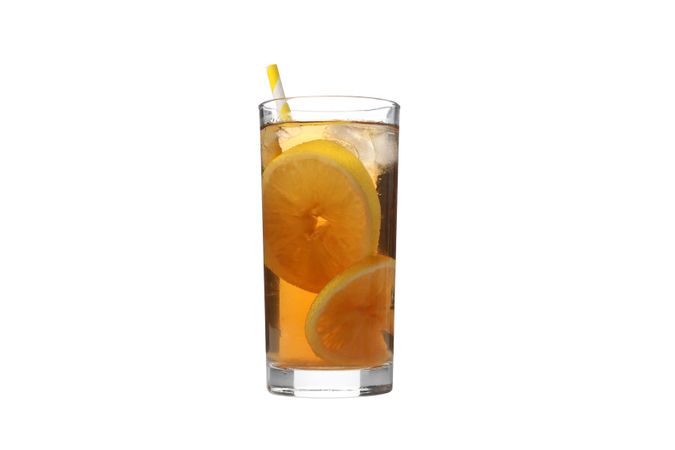 A glass of cold tea with an orange, isolated on plain background