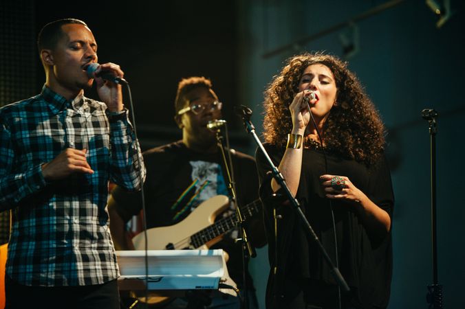 Los Angeles, CA, USA - September 15th, 2014: Woman and two men singing on stage with band