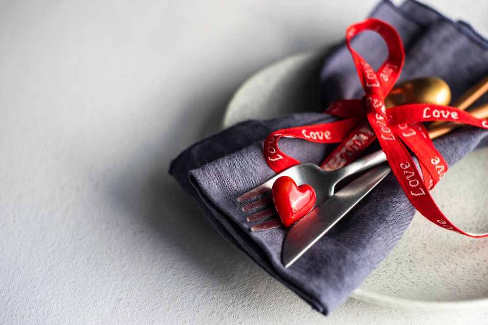 St. Valentine day concept of heart decorations with cutlery