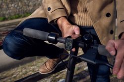 Anonymous man turning on scooter