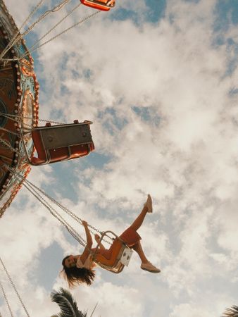 Smiling woman sitting on carousel