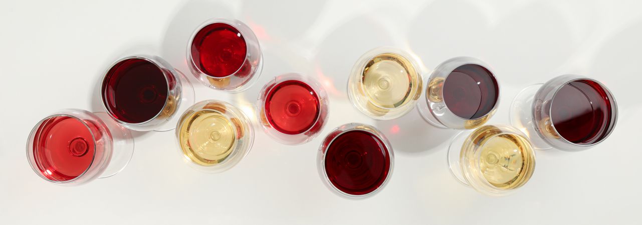 Flat lay composition. Glasses with different wine on plain background, top view