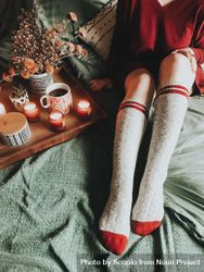 Woman wearing long socks sitting in bed near tray 4OZeZ5