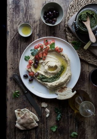 Pesto hummus with tomatoes and beans