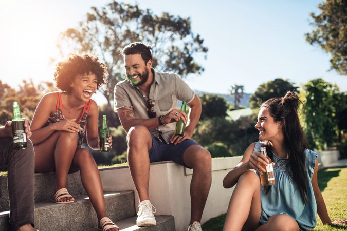 Group of friends enjoying and having drinks at outdoor party