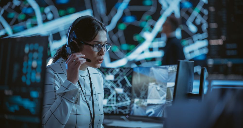 High-Tech Surveillance Office with Specialists Using Satellite Technology with Real-Time Monitoring, CCTV and Traffic Reports.