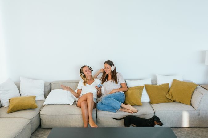 Delighted women singing on couch