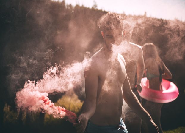 Friends lighting smoke torch