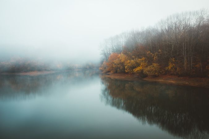 Tranquil water of lake in mist