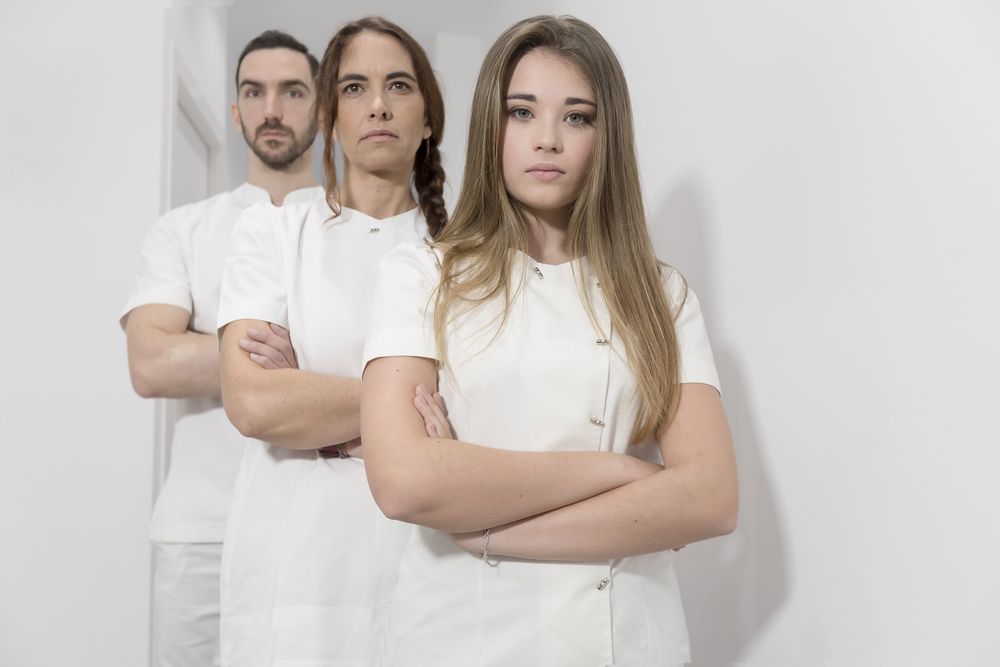 Portrait of serious group of medical staff standing in bright office