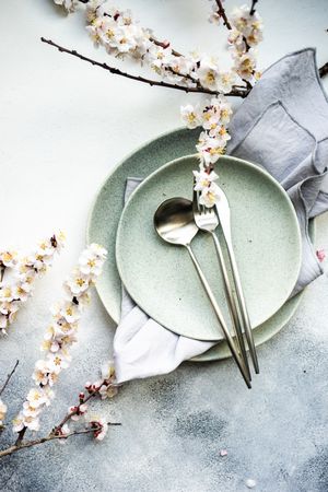 Top view of table setting of apricot blossom branches surrounding plates