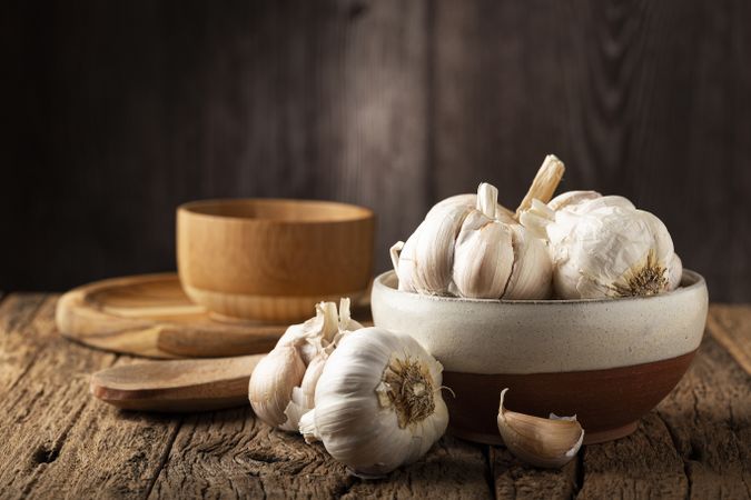 Garlic bulb and garlic cloves on the wooden table.