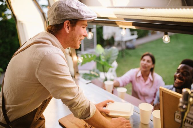 Male cook giving orders to clients