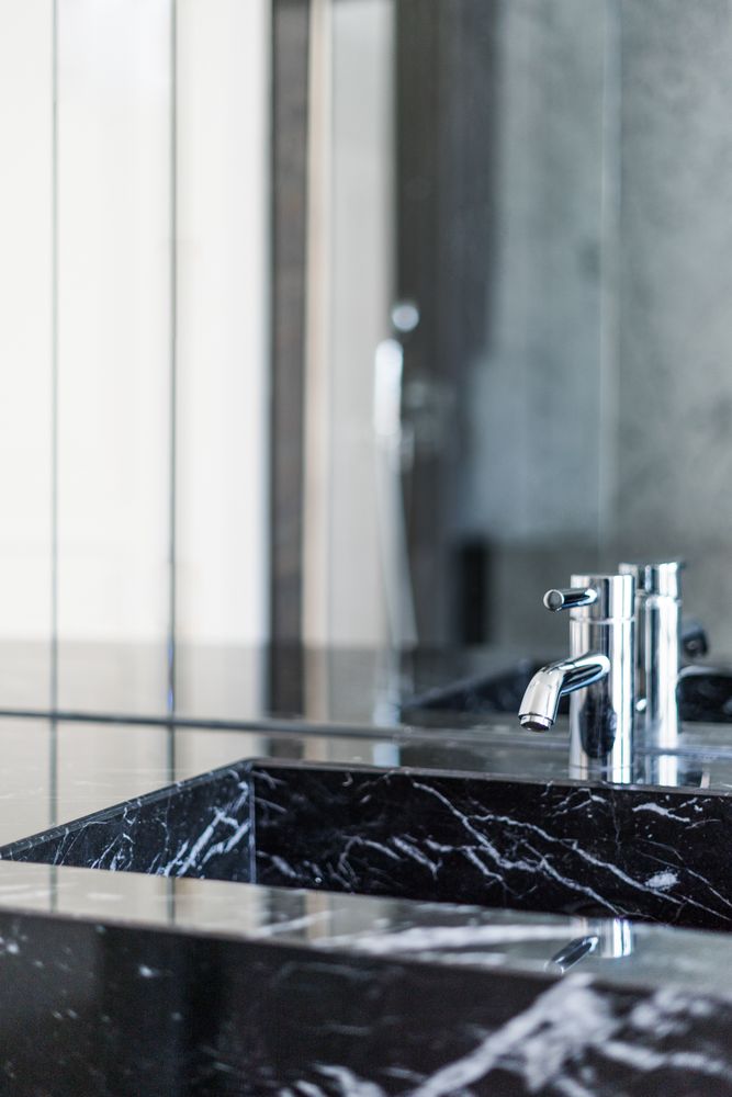 Marble sink and water tap in contemporary washroom