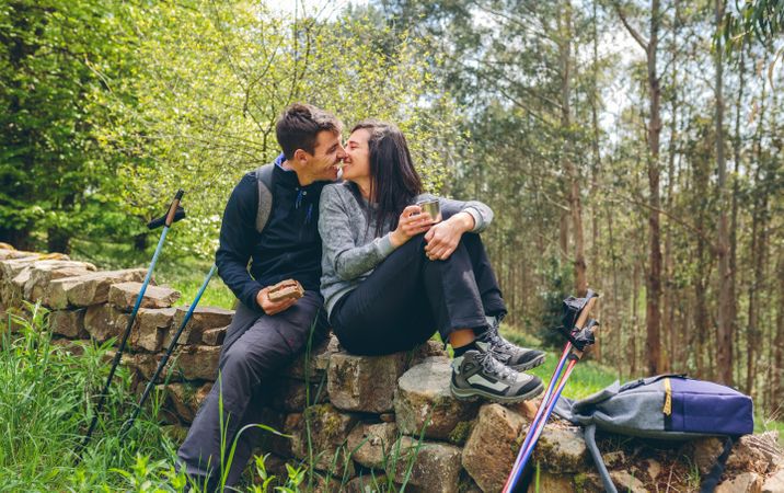 Couple about to kiss while making a break to do trekking