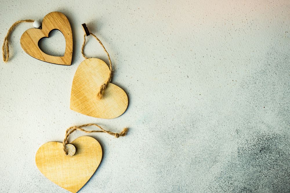 Valentine's day concept with three wooden heart decorations 