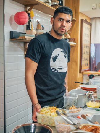 Young male working in Asian cafe