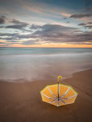 Umbrella on beach near sea
