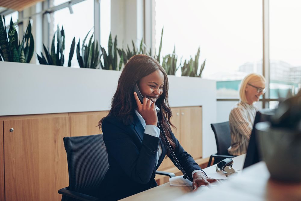 Two women at the front desk smiling