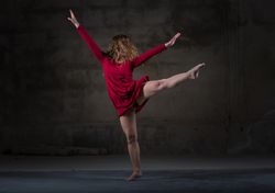 Young woman dancing in darkness