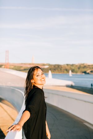Trendy female standing on urban background