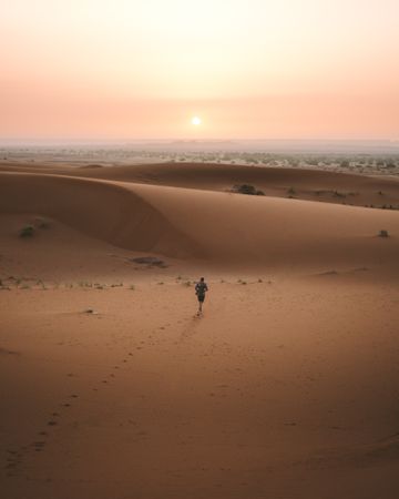 man in summer shirt walking in desert