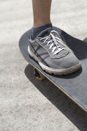 Close up of a young shoe on skateboard