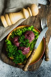 Top view of traditional Georgian dish beet dish, pkhali with peppermill