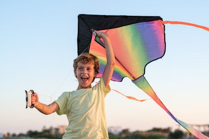 Happy boy having fun with kite