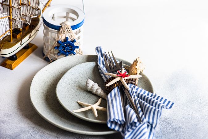 Marine table setting with sea stars and shells with copy space