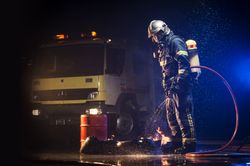 Muscular firefighter on mission