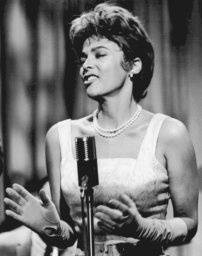 American actress and singer Dorothy Jean Dandridge at the microphone in ballgown